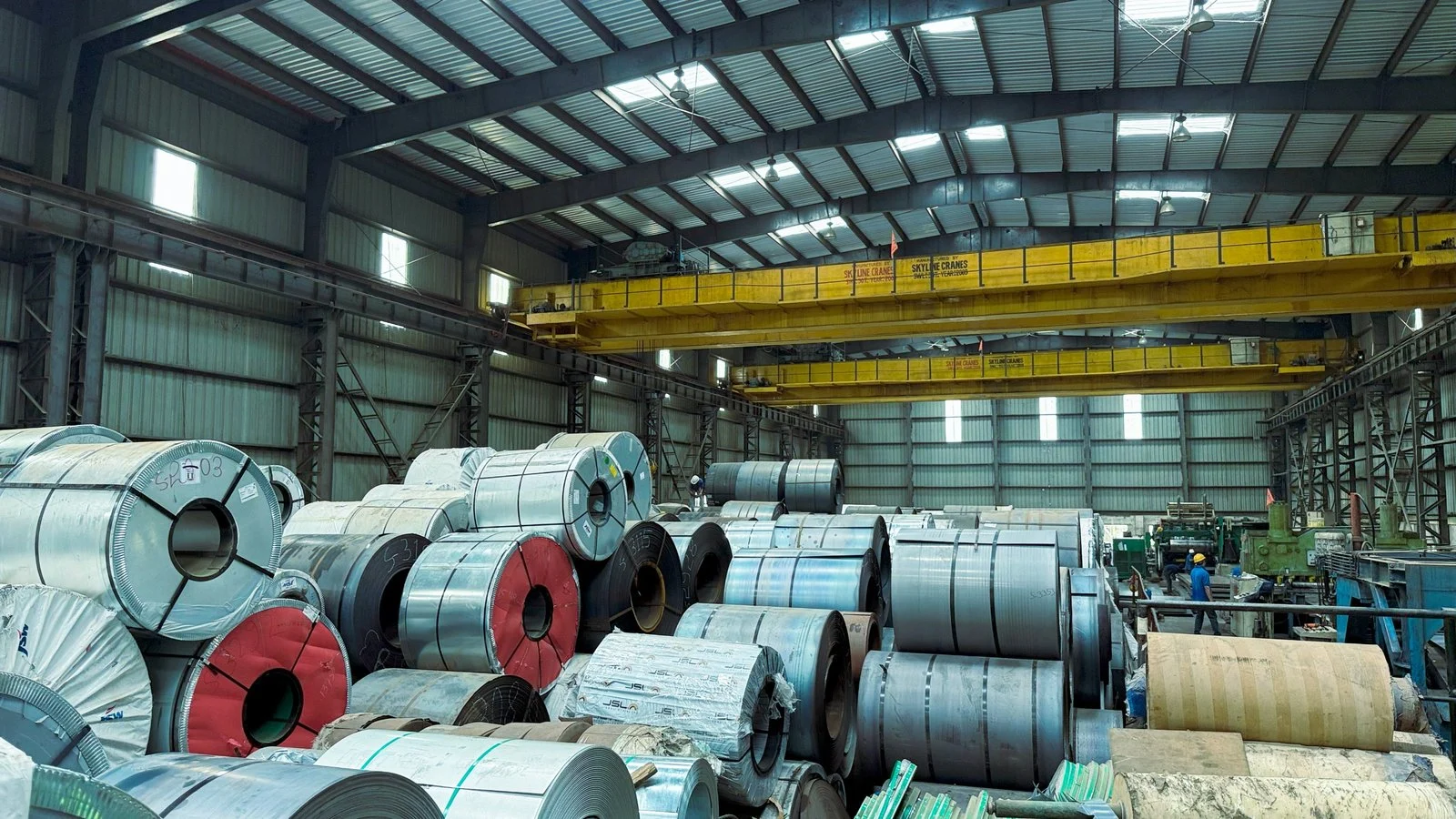 Steel coils stored under overhead cranes in the factory